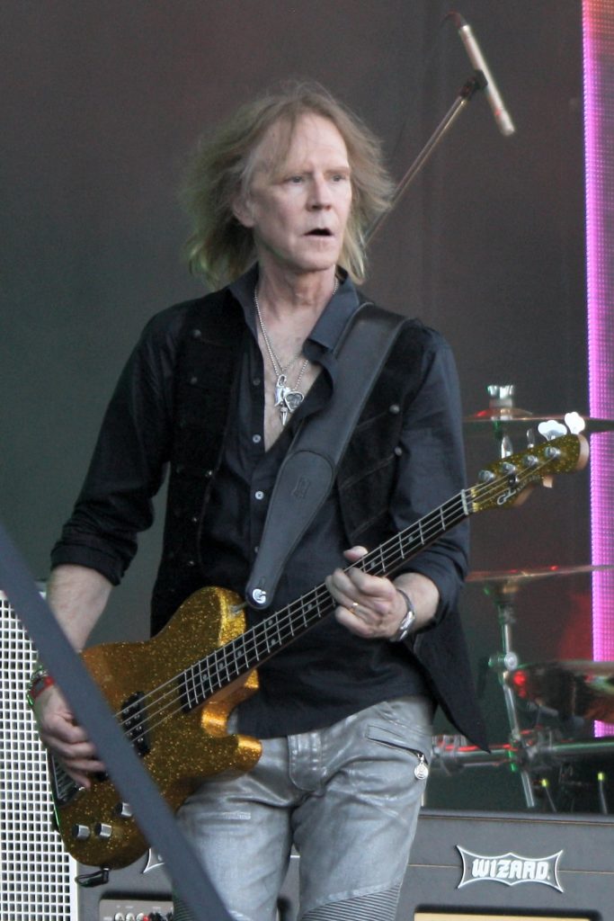 Tom Hamilton — Thin Lizzie 2016 live on stage at Ramblin' Man Fair in Mote Park, Maidstone. The line up for this show was Ricky Warwick - lead vocals,acoustic guitar, Scott Gorham - guitar, Damon Johnson - guitar Tom Hamilton - bass guitar (Aerosmith), Scott Travis - drums, Darren Wharton - keyboards. They were joined for 4 songs by Midge Ure (Ultravox) who had toured with Lizzie on a 1979 US tour. The set was a tribute to Phil Lynott 30 years to the day after his death from alcohol poisoning and included Jailbreak, Boys are Back in Town, Thunder & Lightning, Dancing in the Moonlight, Rosalie, Cowboy Song, Chinatown, Killer on the Loose and a great crowd singalong of Whiskey in the Jar. Lizzie were second on the bill, but blew Whitesnake off the stage, as these guys can still cut it whereas Coverdale & co certainly cannot.