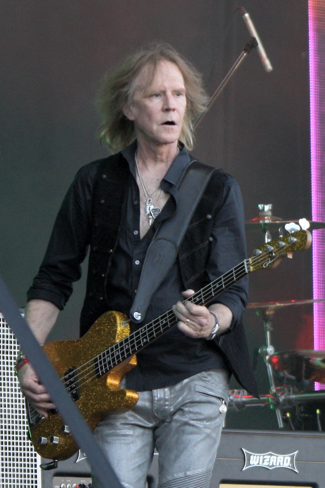 Tom Hamilton — Thin Lizzie 2016 live on stage at Ramblin' Man Fair in Mote Park, Maidstone. The line up for this show was Ricky Warwick - lead vocals,acoustic guitar, Scott Gorham - guitar, Damon Johnson - guitar Tom Hamilton - bass guitar (Aerosmith), Scott Travis - drums, Darren Wharton - keyboards. They were joined for 4 songs by Midge Ure (Ultravox) who had toured with Lizzie on a 1979 US tour. The set was a tribute to Phil Lynott 30 years to the day after his death from alcohol poisoning and included Jailbreak, Boys are Back in Town, Thunder & Lightning, Dancing in the Moonlight, Rosalie, Cowboy Song, Chinatown, Killer on the Loose and a great crowd singalong of Whiskey in the Jar. Lizzie were second on the bill, but blew Whitesnake off the stage, as these guys can still cut it whereas Coverdale & co certainly cannot.